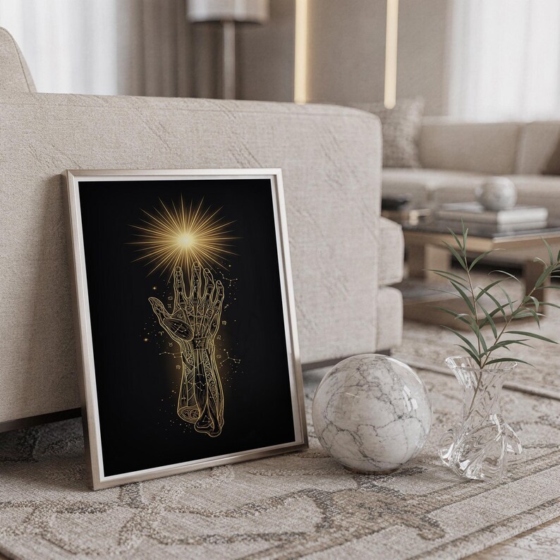 Celestial hand wall art print standing on a countertop in a modern white kitchen.