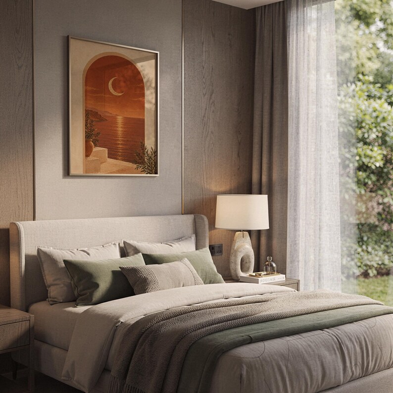 Mediterranean crescent moon arch print hanging above a bed with sage green pillows in a calm neutral bedroom.