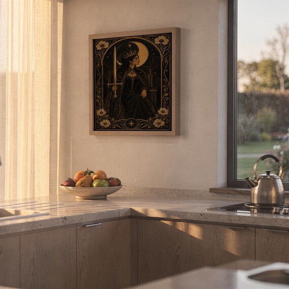 Gothic moon queen wall art print hanging above a stone countertop with a fruit bowl in a sunny kitchen.
