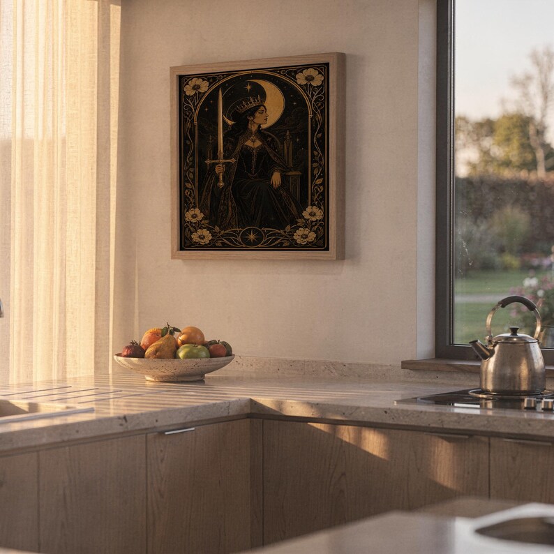 Gothic moon queen wall art print hanging above a stone countertop with a fruit bowl in a sunny kitchen.
