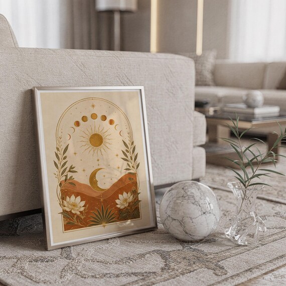 Celestial sun and moon wall art print standing on a countertop in a modern white kitchen.