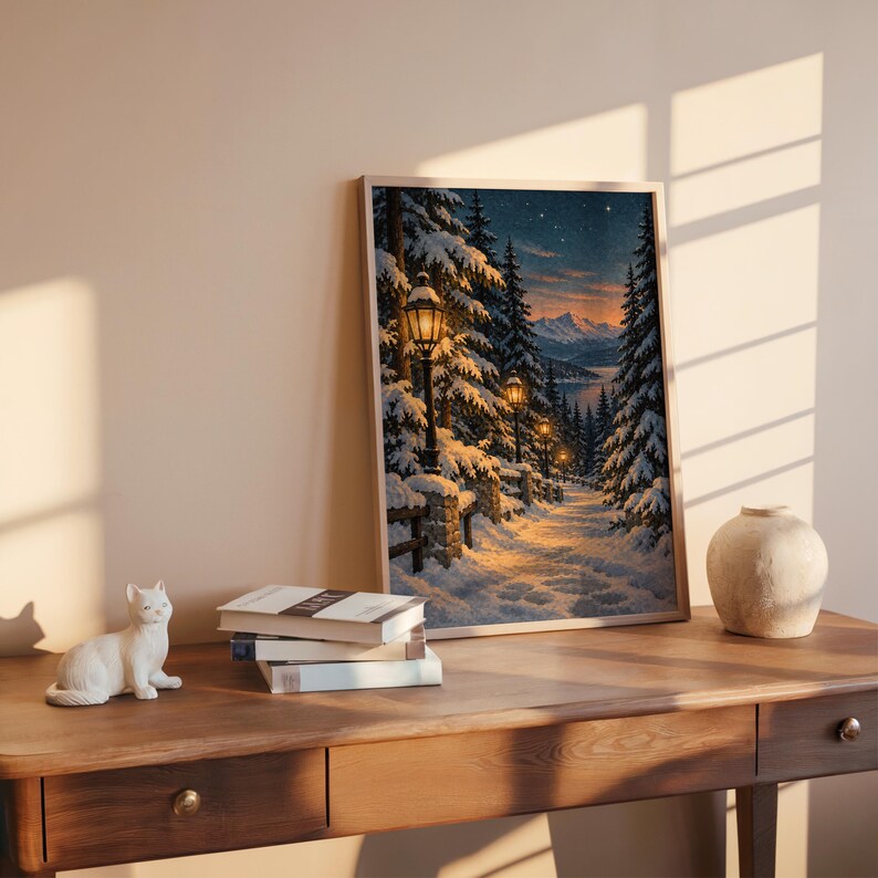 Snowy forest path wall art print leaning on a wooden desk against a warm beige wall in soft window sunlight.
