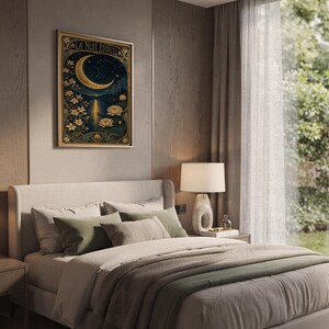An Art Nouveau moon framed print hangs on a wood-paneled wall above a bed.