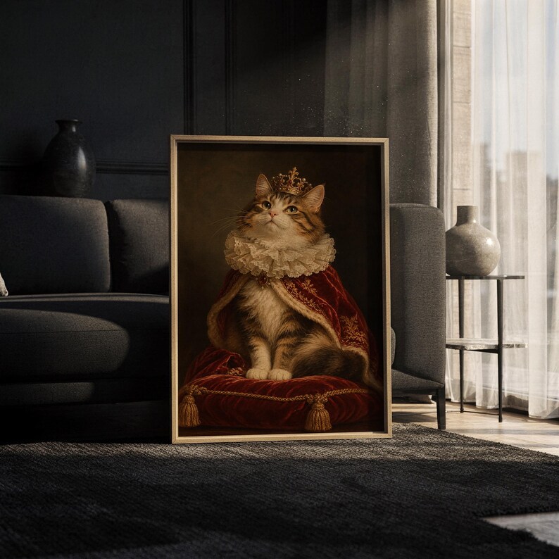 Royal cat portrait wall art print leaning against a white sofa in a bright living room with sheer curtains.