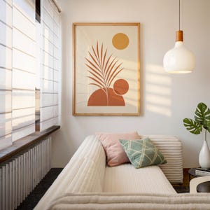 Boho palm leaf wall art with terracotta sun framed above modern sofa in sunlit room