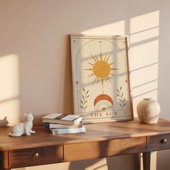 Minimalist boho sun poster framed on wooden desk in warm sunlight with ceramic vase
