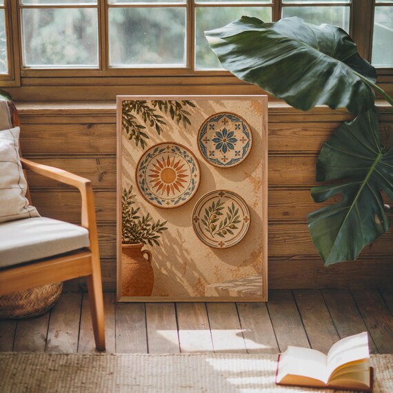 Mediterranean ceramic plate wall art print leaning against warm wood paneling beside a wooden armchair and a monstera plant.