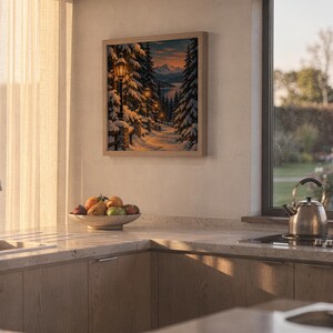 Snowy forest path wall art print hanging above a stone countertop with a fruit bowl in a sunny kitchen.