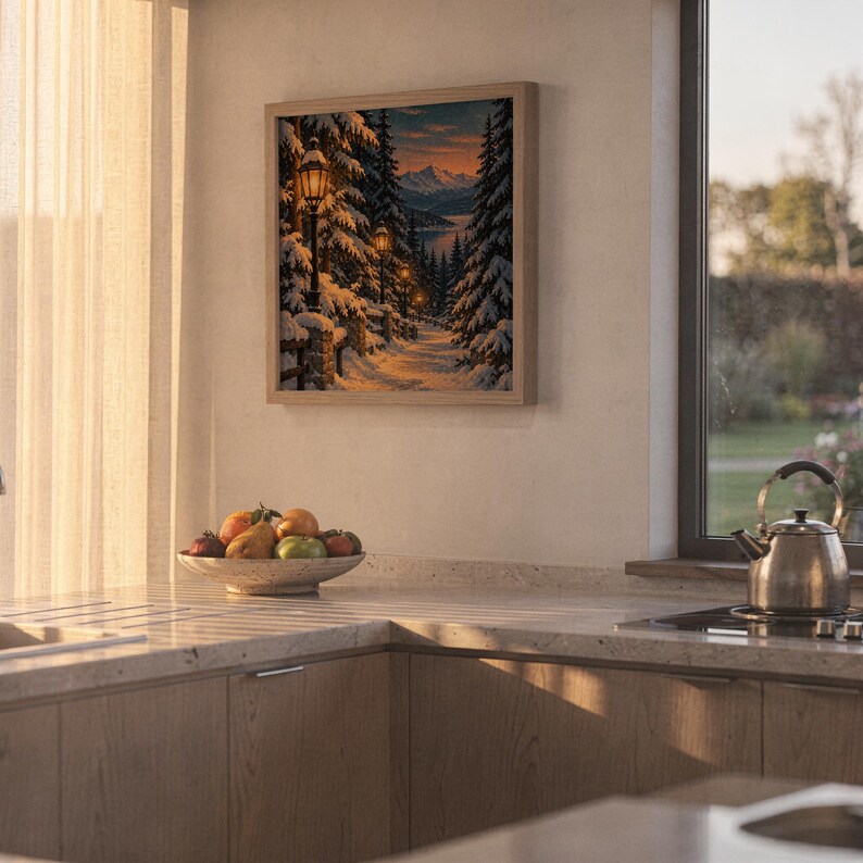 Snowy forest path wall art print hanging above a stone countertop with a fruit bowl in a sunny kitchen.