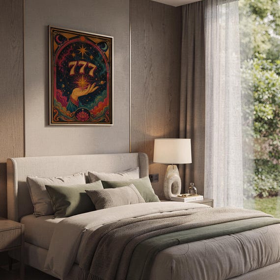 777 angel number wall art print hanging above a bed with sage green pillows in a calm neutral bedroom.