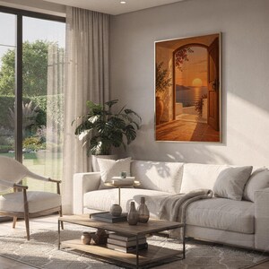 Mediterranean sunset doorway wall art print hanging above a white sofa in a living room with garden views.