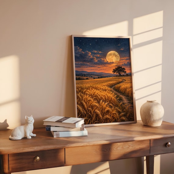 Moon wall art print leaning on a wooden desk against a warm beige wall in soft window sunlight.