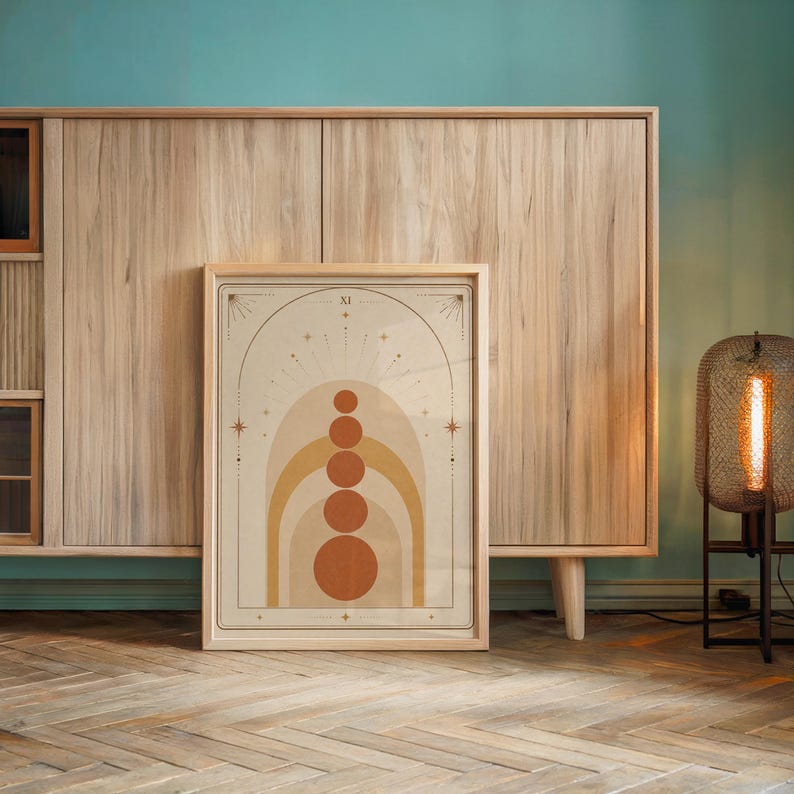 Mid century abstract arch wall art framed on wooden console table against accent wall.