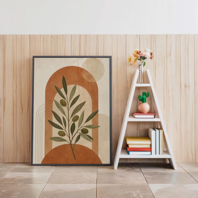 Terracotta arch poster in black frame beside white decorative ladder shelf