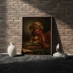Dachshund wall art print in a white frame leaning against a gray sofa on a sunlit wooden floor.