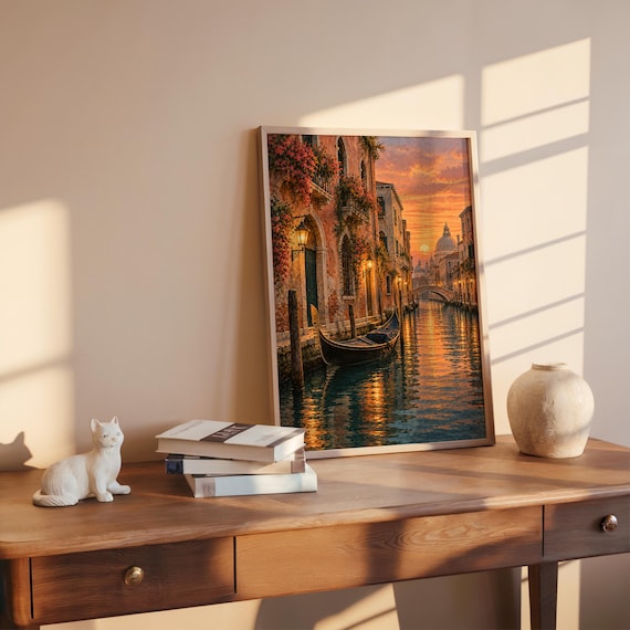 Venice canal sunset wall art print hanging above a bed with sage green pillows in a calm neutral bedroom.