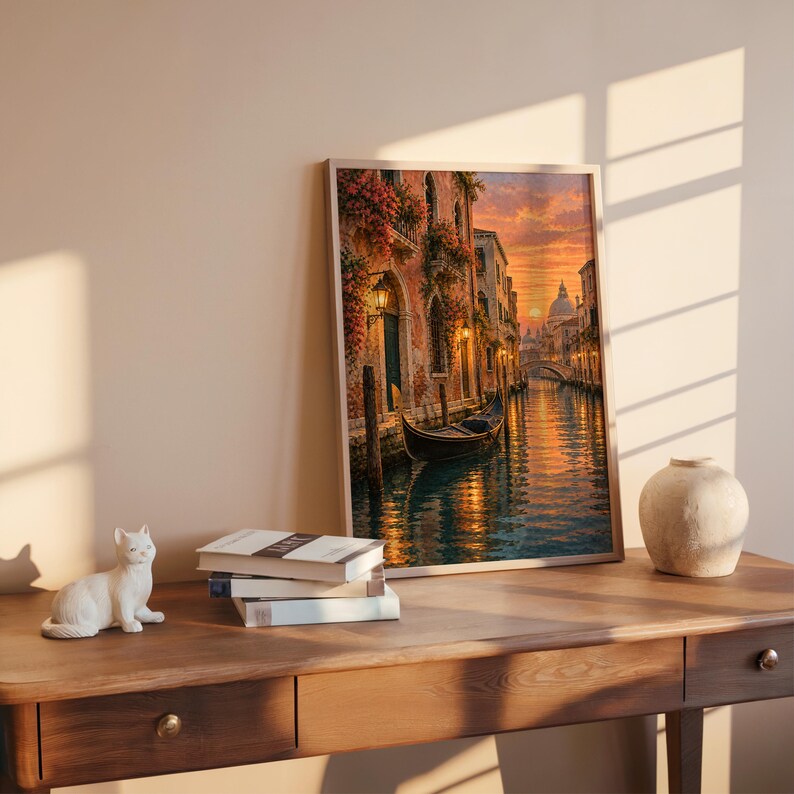 Venice canal sunset wall art print hanging above a bed with sage green pillows in a calm neutral bedroom.