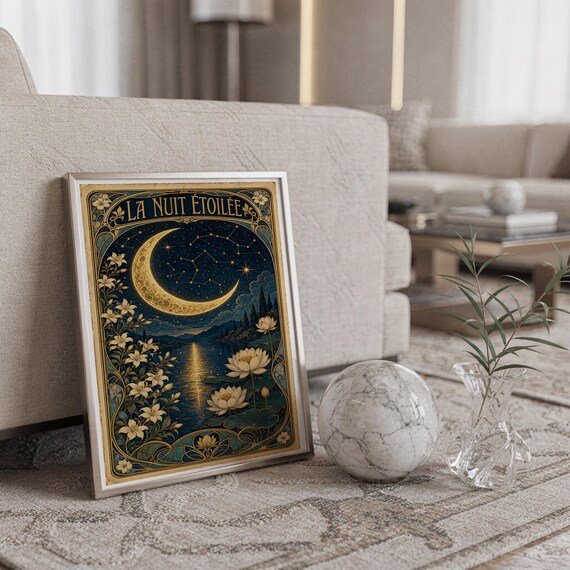 A framed vertical art print titled La Nuit Etoilee leaning against a sofa next to a marble sphere and a glass vase.