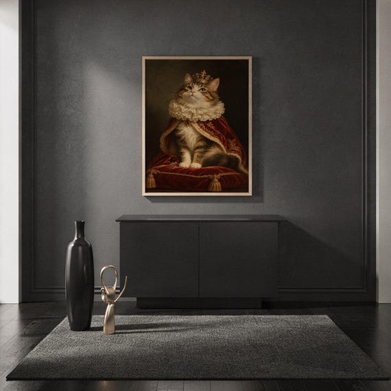 Royal cat portrait wall art print standing on a countertop in a modern white kitchen.