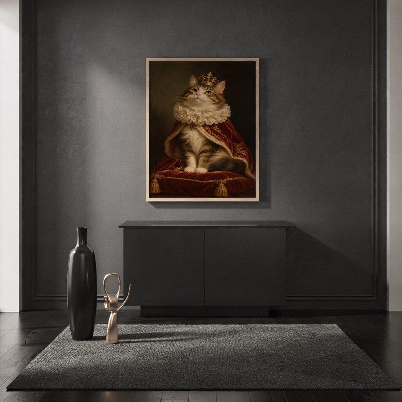 Royal cat portrait wall art print standing on a countertop in a modern white kitchen.