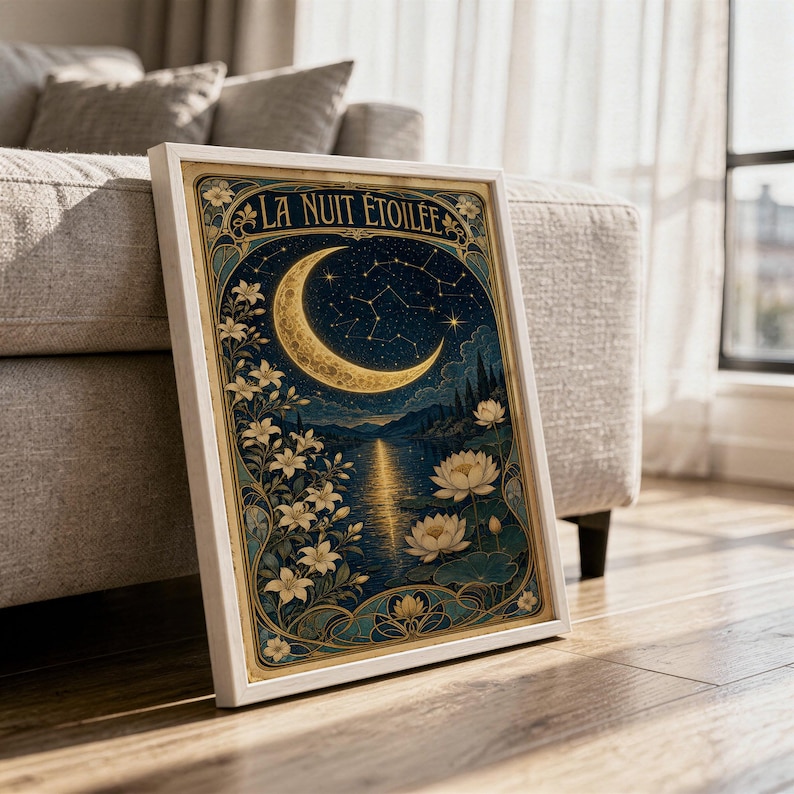 A framed Art Nouveau moon poster rests on a wooden floor near a couch.
