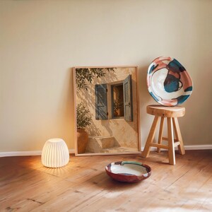 Print size guide for the mediterranean blue shutter wall art print: framed examples in 12x16, 16x20, 18x24, 23.4x33.1 and 24x36 inches on a warm beige wall above a cream sofa; 14 sizes available from 5x7 to 36x48 inches, prints ship unframed.