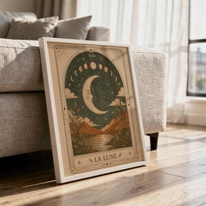Terracotta moon tarot card print framed on hardwood floor in sunlit living room decor.