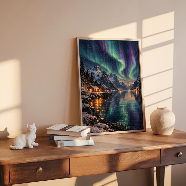 Aurora borealis mountain landscape wall art print leaning on a wooden desk against a warm beige wall in soft window sunlight.
