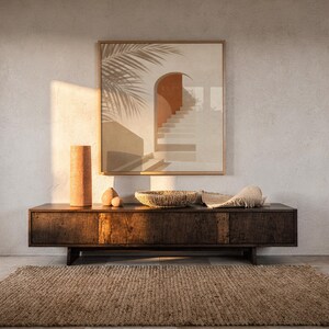 Terracotta arch print poster displayed over dark wood credenza sideboard