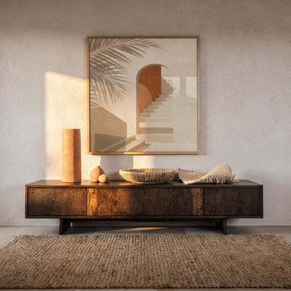 Terracotta arch print poster displayed over dark wood credenza sideboard