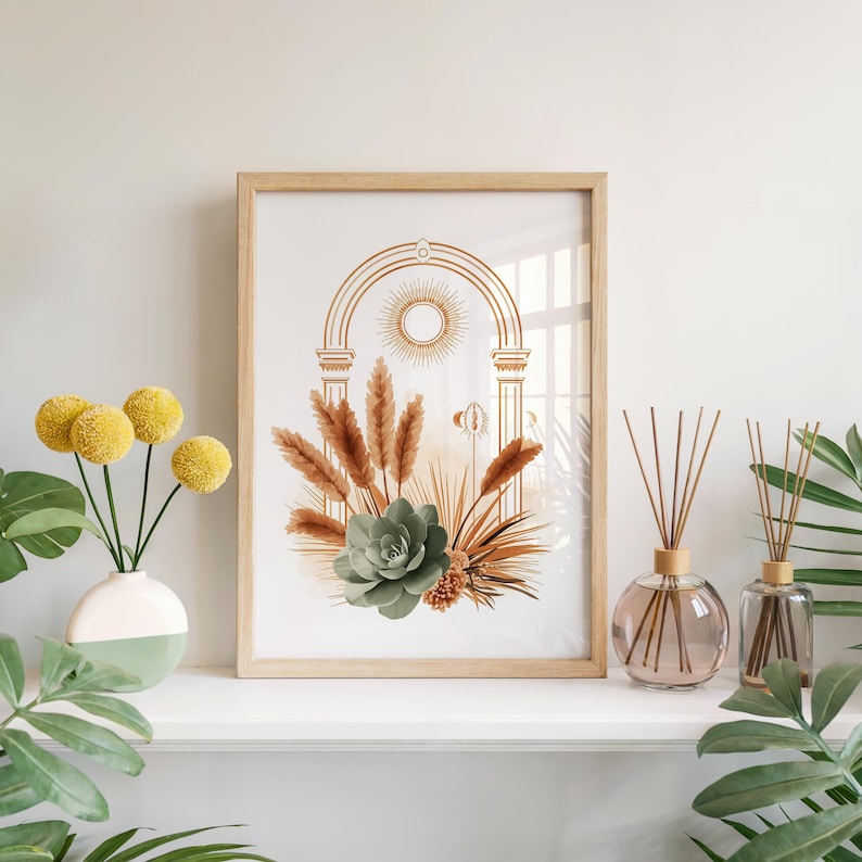 Sage green succulent botanical print framed in light wood set on a bright white fireplace mantel shelf alongside a vase of yellow flowers, glass reed diffusers, and indoor tropical houseplant leaves.