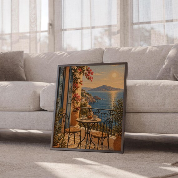 Mediterranean balcony wall art print leaning against a white sofa in a bright living room with sheer curtains.