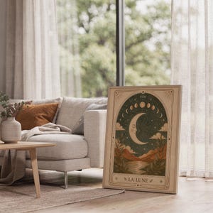 Mystical crescent moon tarot poster framed on bright sunlit living room floor next to window.