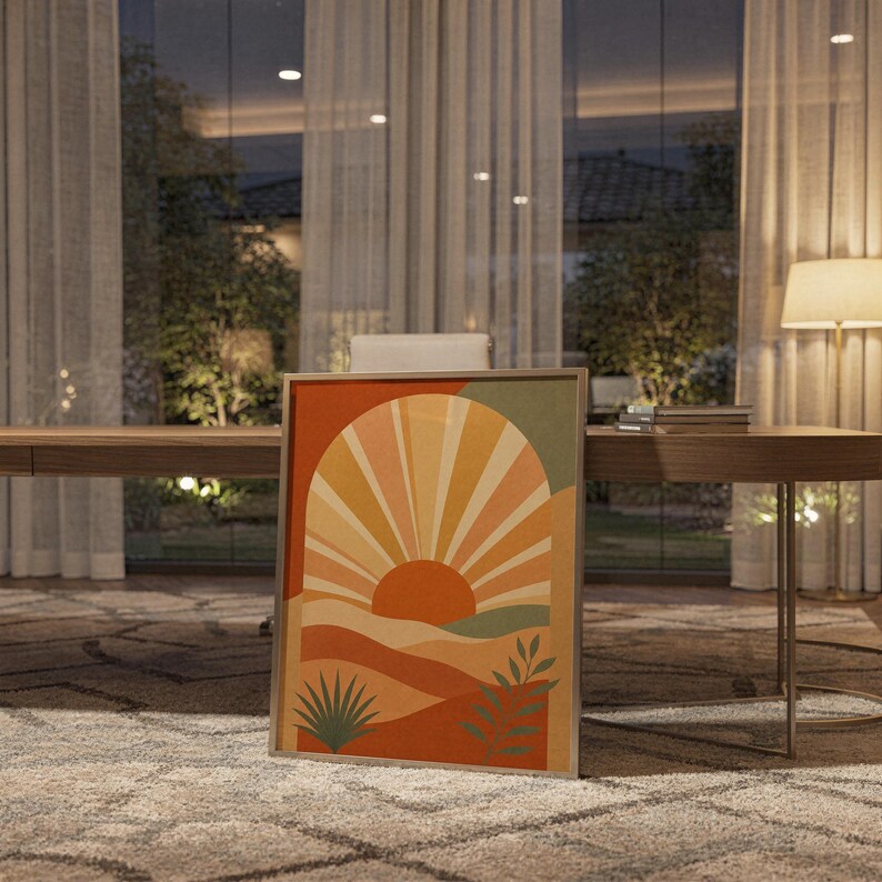 Boho sun arch print standing on a wooden desk in a home office in warm evening light.