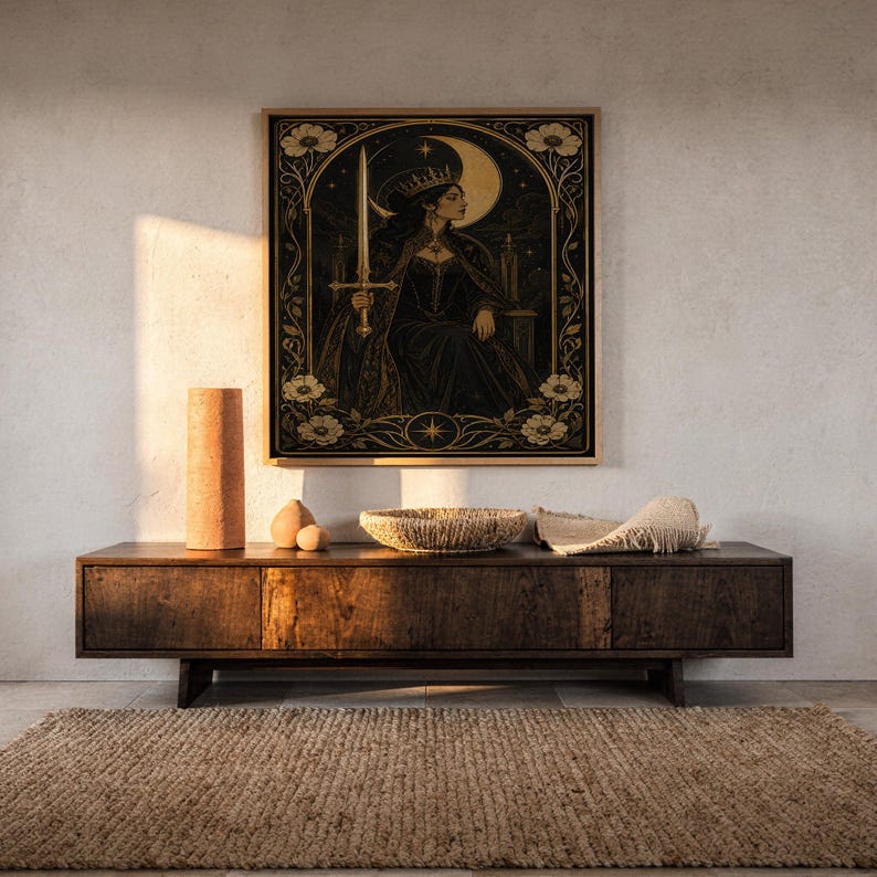 Gothic moon queen wall art print hanging above a dark wood console and jute rug in a warm neutral interior.