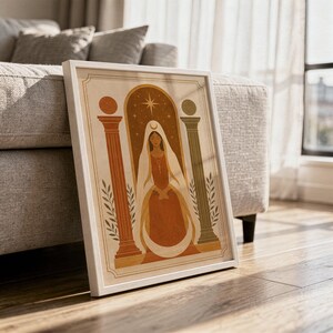 Abstract terracotta pottery wall art in a wooden frame resting on the floor with soft natural sunlight and shadow patterns.