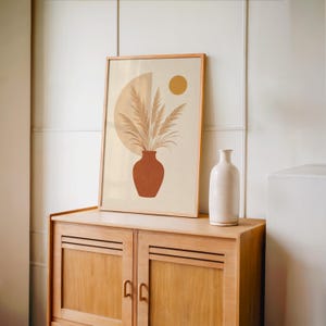 Minimalist pampas grass poster set on vintage wooden sideboard console