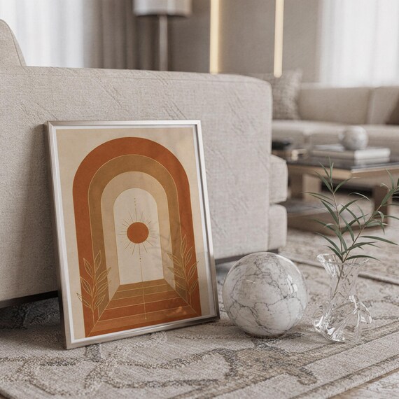 Boho arch sun wall art print standing on a countertop in a modern white kitchen.