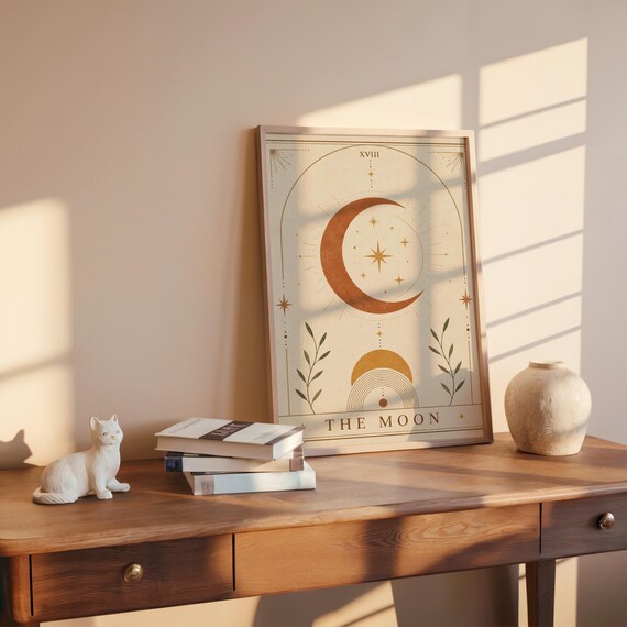 Mystical celestial moon art poster on wooden desk with warm sunlight and ceramic vase.