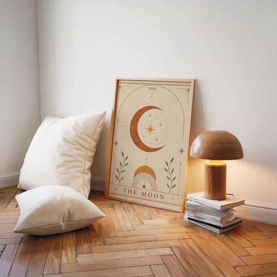 Earthy terracotta moon print on parquet floor with white pillows and floor lamp.
