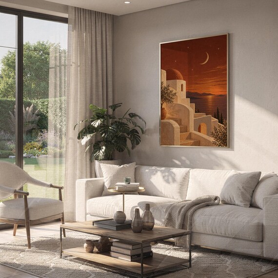 Mediterranean moonlit coastal wall art print hanging above a white sofa in a living room with garden views.
