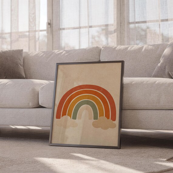 Boho earth tone rainbow print leaning against a white sofa in a bright living room with sheer curtains.