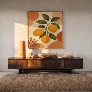 Lemon branch botanical print hanging above a dark wood console and jute rug in a warm neutral interior.