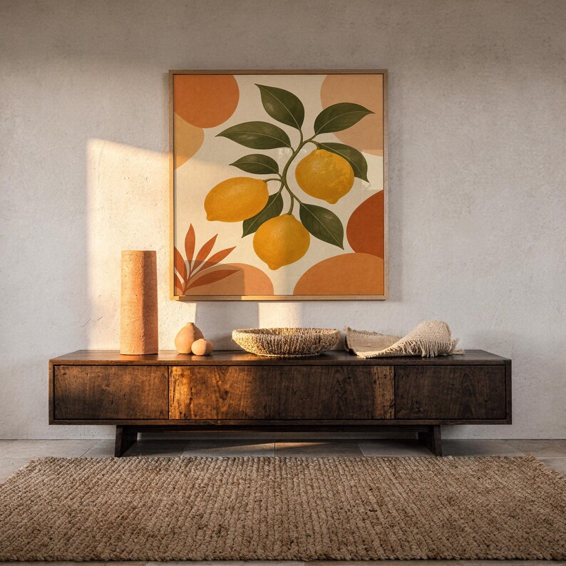 Lemon branch botanical print hanging above a dark wood console and jute rug in a warm neutral interior.
