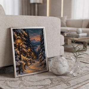 Snowy forest path wall art print in a silver frame leaning against a sofa beside a decorative marble sphere.