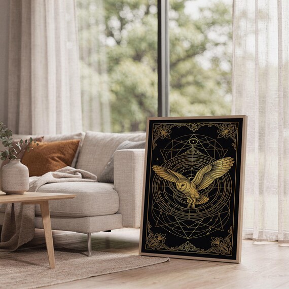 Celestial owl wall art print leaning on the floor beside a cream armchair next to large garden windows.