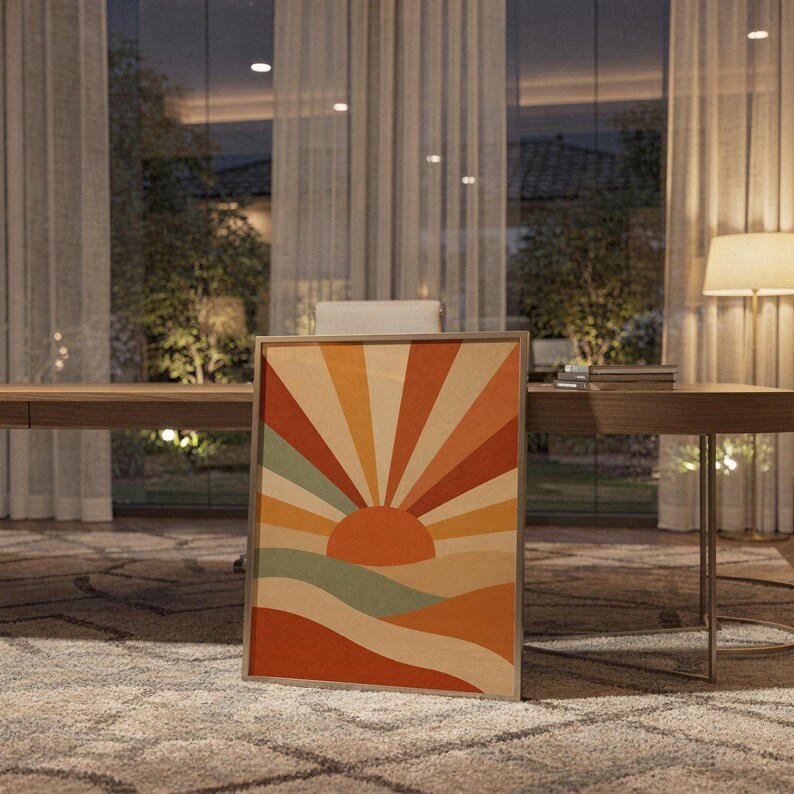 Retro geometric sunrise print standing on a wooden desk in a home office in warm evening light.