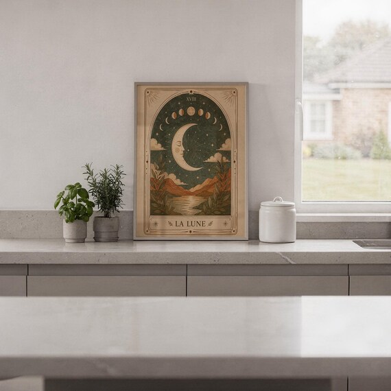 Minimalist spiritual moon tarot print framed on white kitchen counter against clean wall decor.