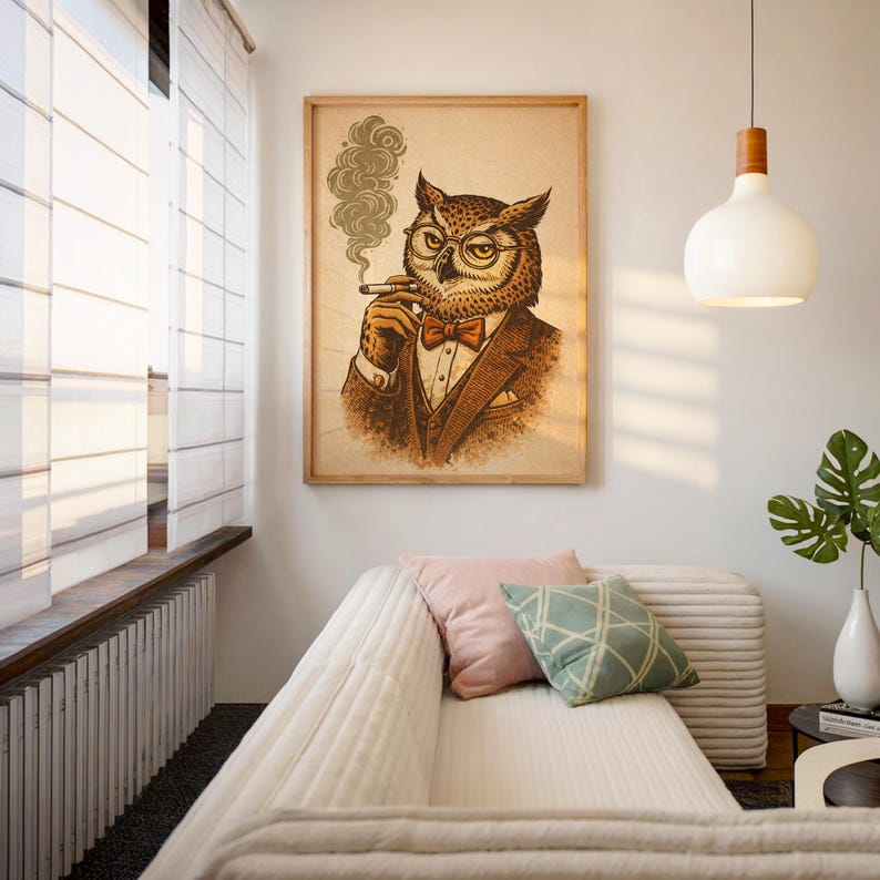 A framed print of an owl in a brown suit, red bow tie, and glasses, smoking a cigar with smoke curling up, leans against a light wood cabinet on a wooden floor.