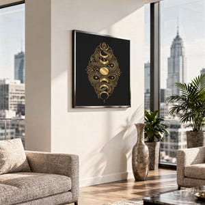 Gold snake moon phase wall art print standing on a white kitchen counter beside potted herbs.